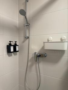a bathroom with a shower with a shower head at Gemütliches Apartment nähe HBF-City--Lift in Hannover +24 photos