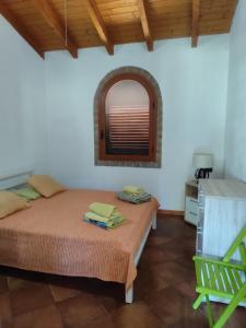 a bedroom with a bed and a window in a room at Villa l'orto Portixeddu Sardegna in Fluminimaggiore