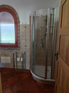 a bathroom with a shower with a glass door at Villa l'orto Portixeddu Sardegna in Fluminimaggiore