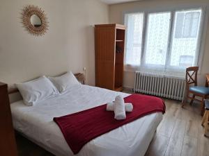 a bedroom with a bed with a towel on it at La cocotte in Soullans