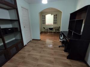 a hallway with a dining room and a table at República Minas Novas in Ouro Preto