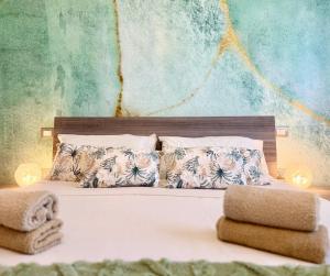 a bedroom with a bed with two towels on it at Cagliari AirPort Apartment in Elmas