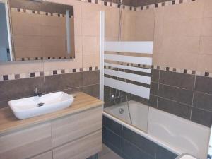 a bathroom with a sink and a shower and a tub at Résidence Le Provence in Les Arcs sur Argens