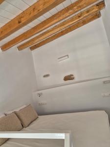 a room with a bed and a wooden ceiling at Koko Room's 2 in Dhriopís
