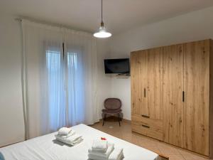a bedroom with a bed and a wooden cabinet at CasaMirea in Lipari