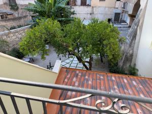 a wooden bench sitting on a balcony with trees at HrD Luxury Rooms in Palermo +84 photos