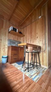 a desk in a room with a wooden wall at Cabañas y tinajas Filkun in Vilcún