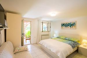 a bedroom with a bed and a tv and a window at Guest House Steel in Dubrovnik