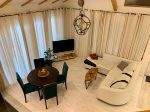 a living room with a couch and a table at MO House Mostar in Kutilivač