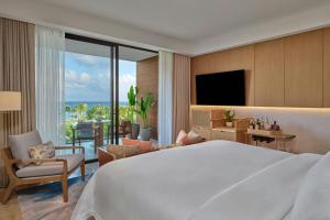 a bedroom with a large bed and a living room at The St. Regis Cap Cana Resort in Punta Cana