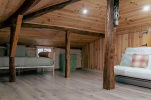 a room with two beds in a wooden attic at Suite La Mansion Casa Rural in La Toba