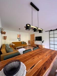 a living room with a large wooden table and a couch at Die Ente an der Enz, mit Schwimmbad und Sauna in Bad Wildbad +33 photos