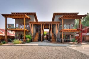a building with wooden structures with a staircase on it at Stylish Casita Moab 2 - In Town, Outdoor Sauna in Moab