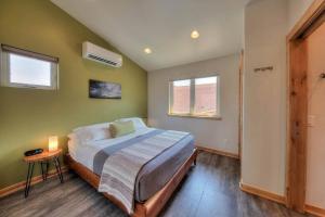 a bedroom with a bed and two windows at Stylish Casita Moab 2 - In Town, Outdoor Sauna in Moab