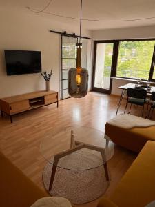 a living room with a couch and a table at Die Ente an der Enz, mit Schwimmbad und Sauna in Bad Wildbad