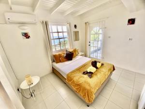 a bedroom with a bed with a teddy bear on it at Le Maison Apartments-Gran Anse in Morne Rouge