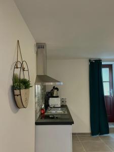 a kitchen with a stove top oven next to a window at Au cocon des promenades in Pesmes +7 photos