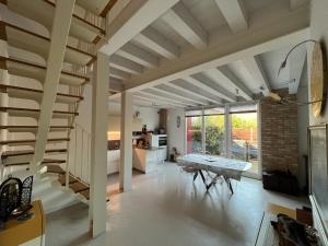 a living room with a staircase and a table at Le Vele Del Cigno in Peschiera del Garda