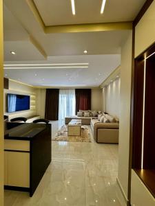 a large living room with a couch and a table at Urban Haven in Madinaty