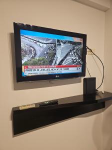 a flat screen tv sitting on a black shelf at Tempora 621 in Buenos Aires