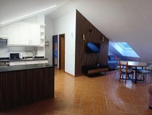 a kitchen and living room with a table and a dining room at Apartamento Rio Gallo II in Cuntis