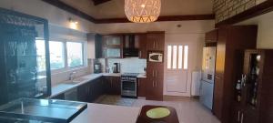 a kitchen with a sink and a stove top oven at Guest House Kastraki in Nafpaktos