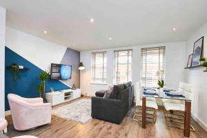 a living room with a couch and a dining room table at Park Square Apartments Leeds in Central Station