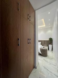 a bedroom with wooden cabinets and a bed at Xplora Real Estate in Gwarinpa