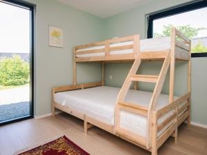 a bedroom with bunk beds and a large window at 6 person holiday home in Juelsminde-By Traum in Sønderby