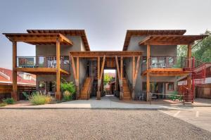 a building with wooden structures with a balcony at Casa Moab 4 - In Town - Outdoor Sauna! in Moab