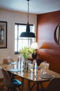a dining room table with a vase of flowers on it at No 1 - Bakewell in Bakewell