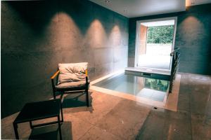 a room with a glass table and a chair and a window at Hôtel L'Echappée Vosgienne - Sport et récupération à 300m du lac in Gérardmer