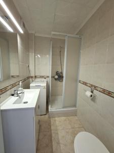 Un baño con ducha, lavabo e inodoro. en Apartment Sea View in Rincon de Loix- free parking, pool, Wi-Fi, new air conditioning, en Benidorm