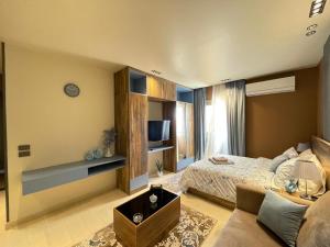 a large bedroom with a bed and a couch at Luxury Studio House 392-4 in 6th Of October