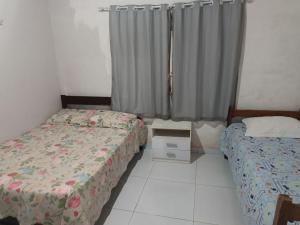 Postel nebo postele na pokoji v ubytování Aluguel por temporada em Luis Correia