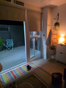 a living room with a sliding glass door at Bee Hive Studio Flat in Manchester