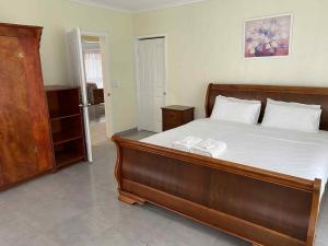 a bedroom with a bed with two towels on it at Modern Family Home in Holonga, Tongatapu in Mount Pritchard