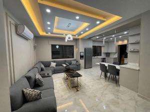 a living room with a couch and a table at شقة واسعة مع ترس كبير in Amman