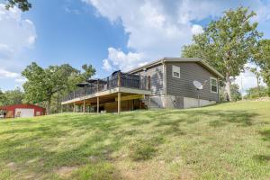 une maison au sommet d'une colline herbeuse dans l'établissement Outdoor Kitchen and Hot Tub Table Rock Lake House, à Golden