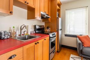 a kitchen with a sink and a stove at Stay Portland - Quirky Micro Apt - Foodies, Artists, Coffee Lovers in Portland