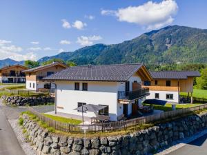 a house in the mountains with a stone wall at Obermöschach 10 in Obermöschach