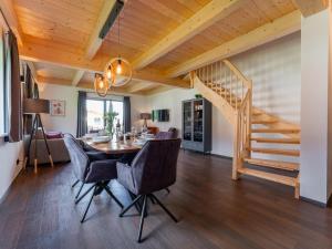 a dining room with a table and chairs and a staircase at Obermöschach 6B in Obermöschach