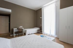 Postel nebo postele na pokoji v ubytování B&B In Centro