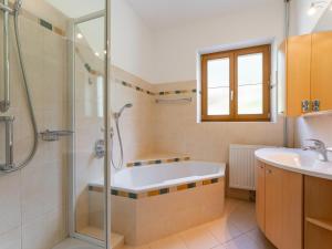 a bathroom with a shower and a tub and a sink at Jukbichl in Laas +108 photos