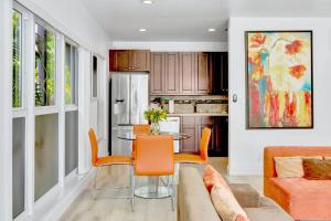 a living room with a table and a couch at Orange Dream on the Water in Fort Lauderdale
