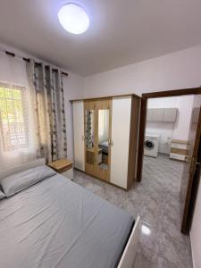 a bedroom with a large bed and a bathroom at Leo's Place in Golem