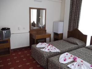 Ein Bett oder Betten in einem Zimmer der Unterkunft Antik Ridvan Hotel