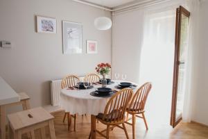 a white dining room with a table and chairs at Apartments with parking space Zagreb - 24661 in Zagreb