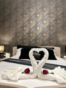two swans made out of towels on a bed at Couple's Getaway in Is-Swieqi