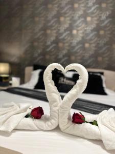 two towels in the shape of a heart on a bed at Couple's Getaway in Is-Swieqi